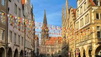 Der Prinzipalmarkt in Münster bei blauem Himmel. Im Hintergrund ist die Lamberti-Kirche zu sehen.