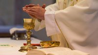 Priester während der Messe bei der Wandlung