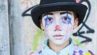 Trauriger Junge als Clown verkleidet